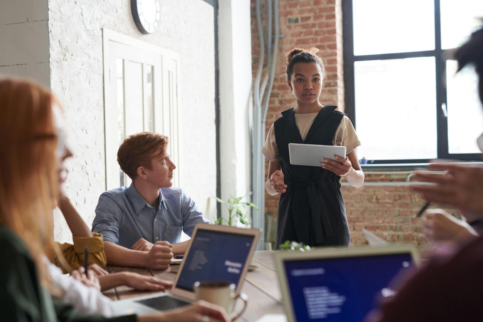 commercial team engaged in a collaborative meeting in a modern office setting.