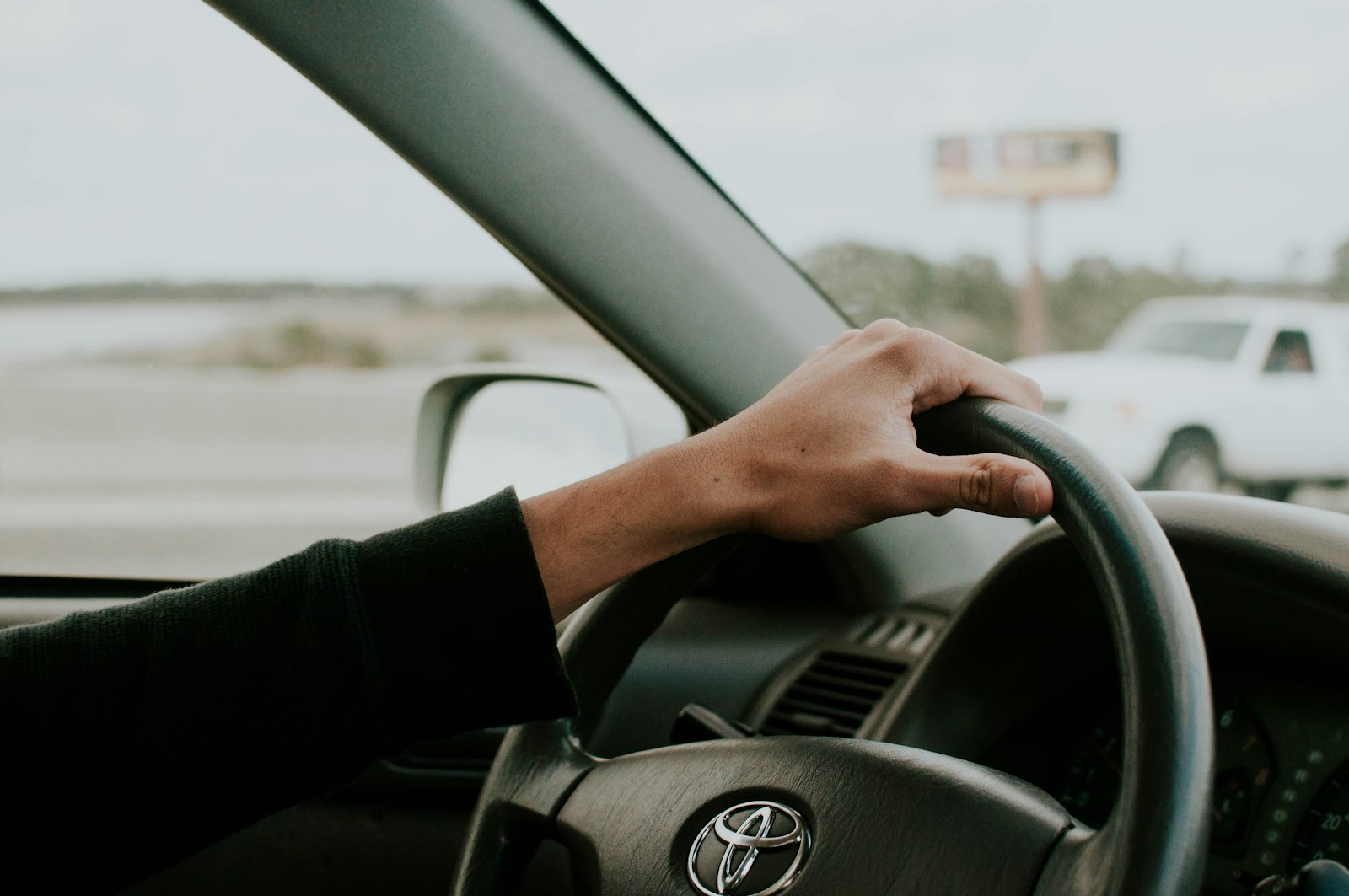 person driving Toyota car auto