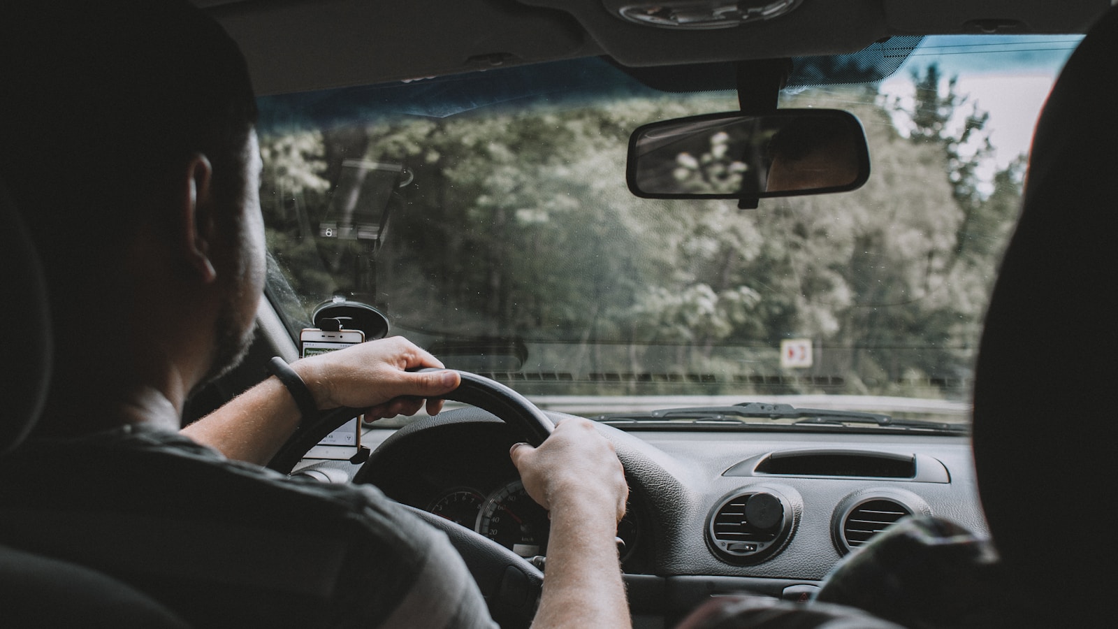 person driving car during daytime auto insurance